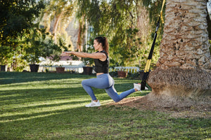 TRX training. A woman preforming a strength workout